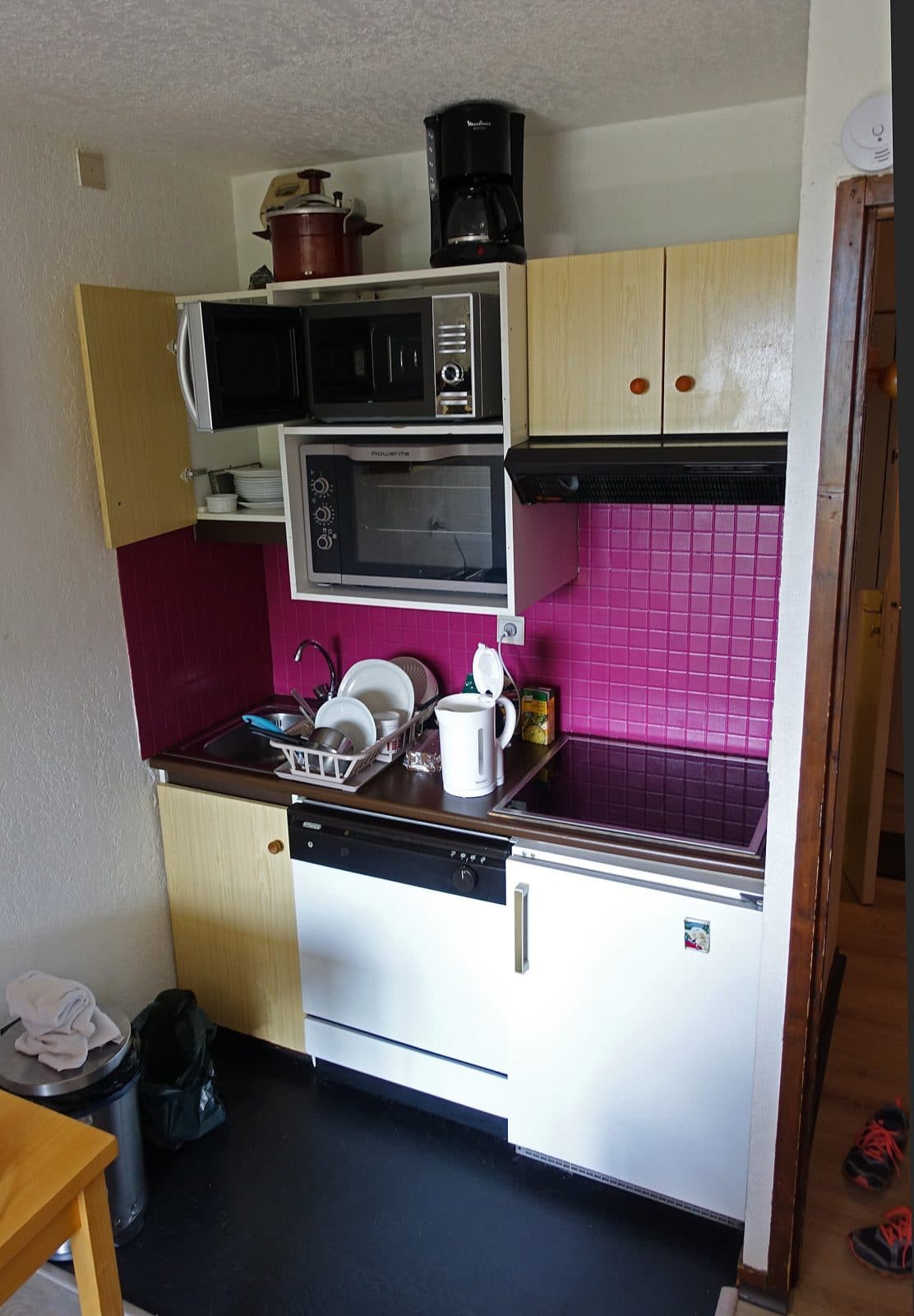 Small kitchenette with sink, counter, and microwave. Amenity reference, not an OPod.