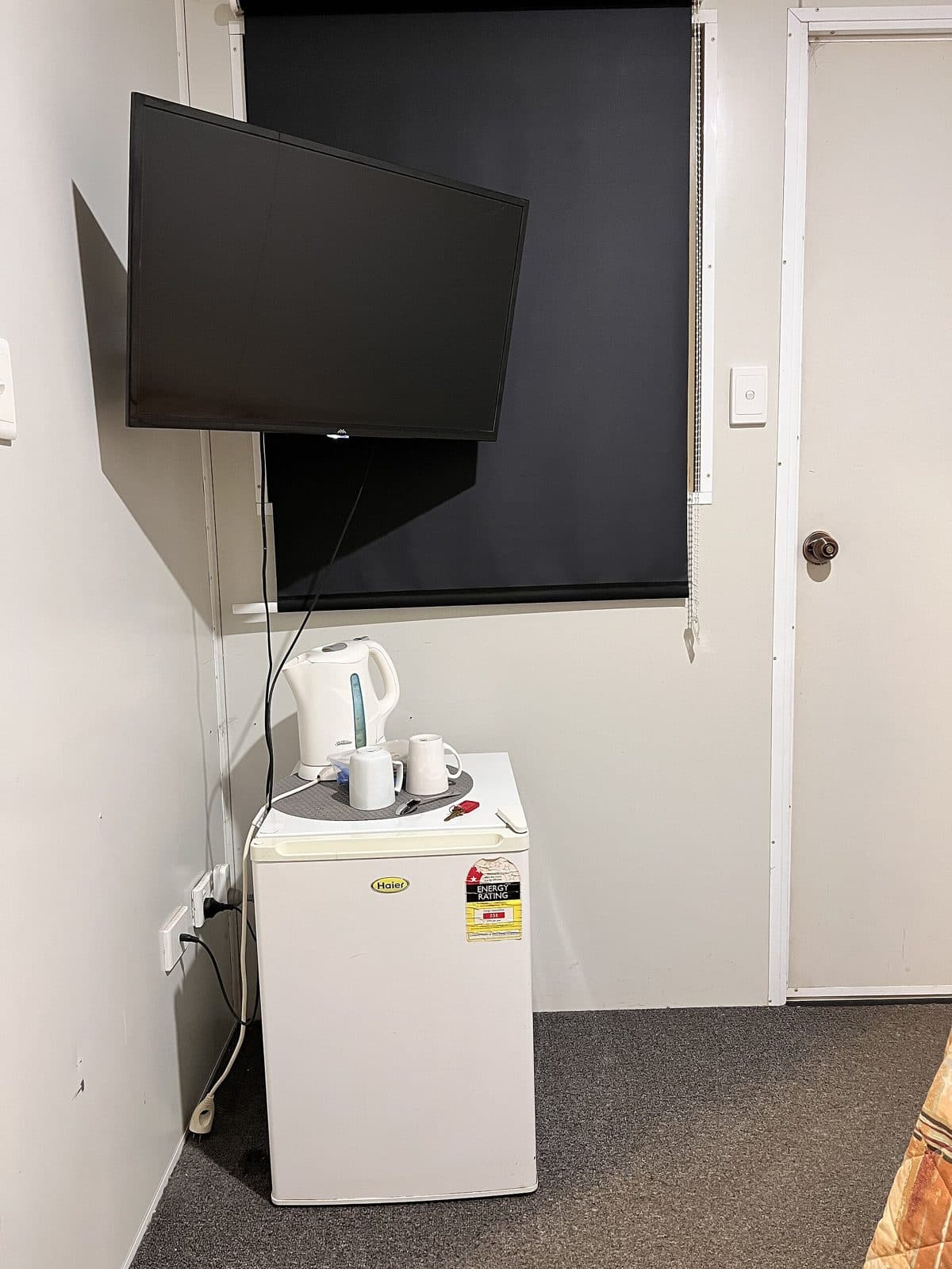 Mini fridge in a hotel room. Amenity reference, not an OPod.